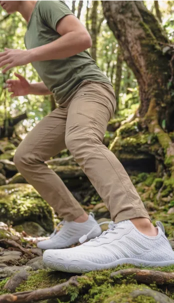 Person hiking through a forested trail in Grounded Footwear barefoot shoes