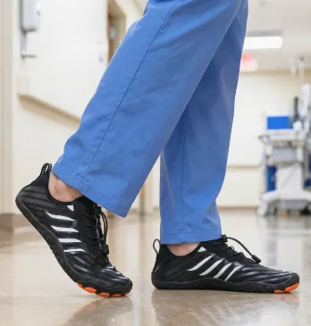 Nurse walking comfortably in hospital hallway wearing black Grounded Footwear barefoot shoes